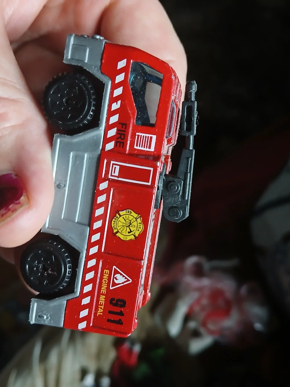 Matchbox Airport Fire Tanker toy vehicle, featuring a red body and a black water